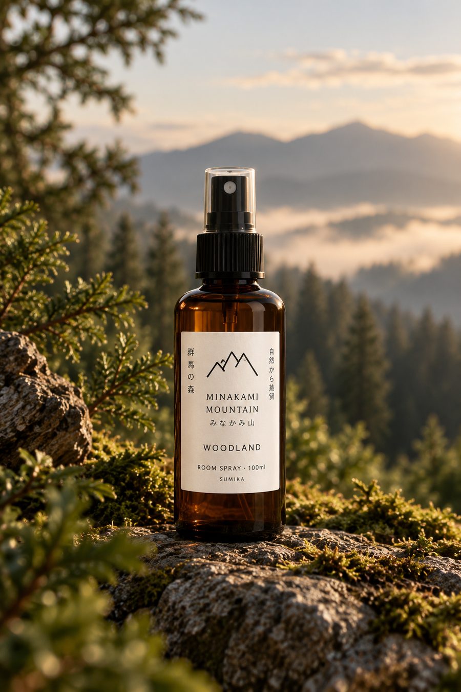 Woodland 100ml room spray on a mossy rock above a misty forest